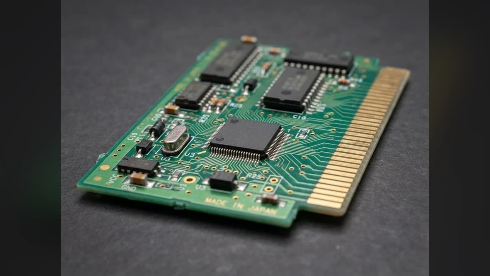 Close-up reference photograph of a retro cartridge PCB with simple IC layout